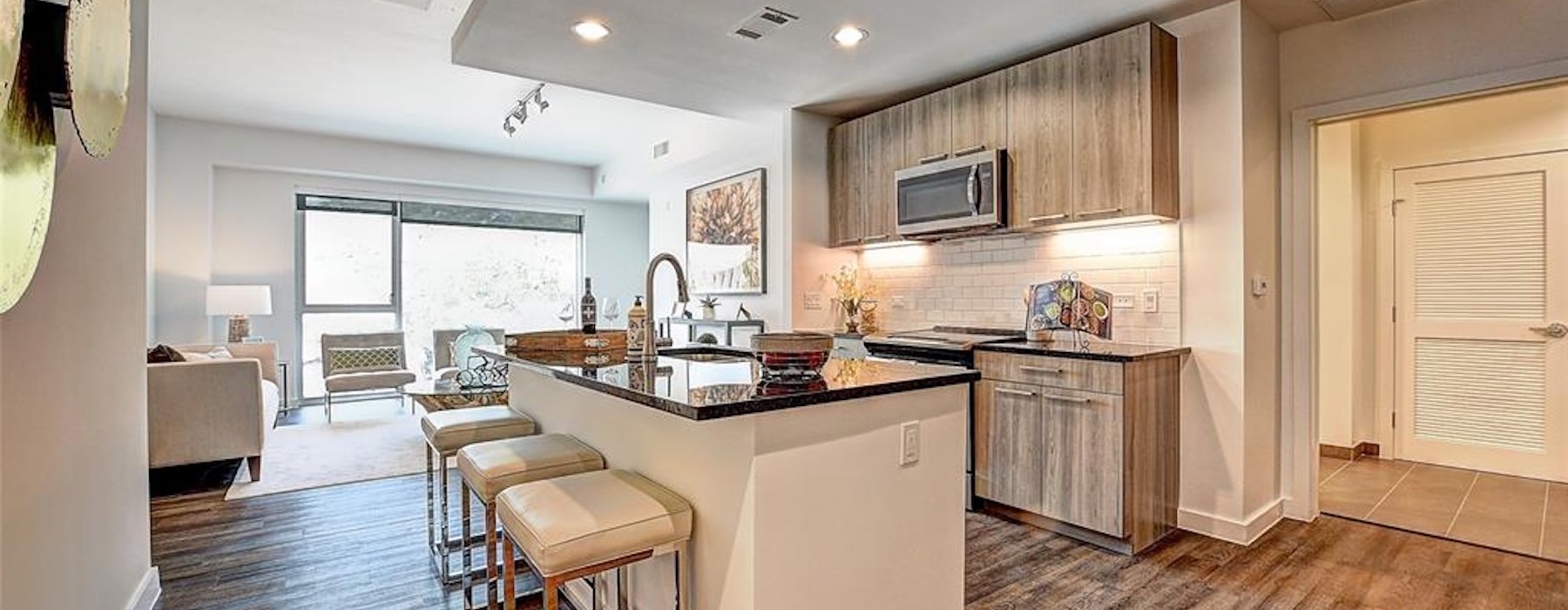 a kitchen with an island and chairs