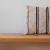 a wooden bench with a striped pillow on it